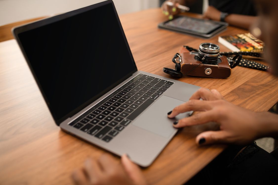 Hands typing on laptop
