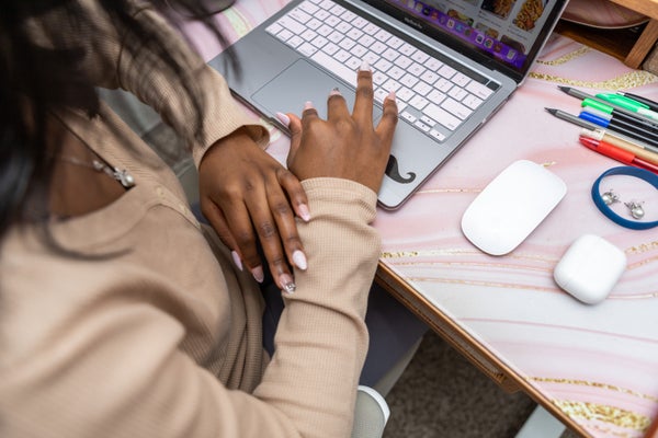 Modern workspace with laptop and writing pens
