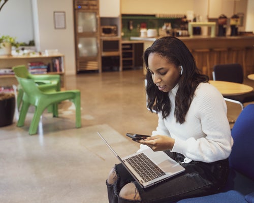 Black woman working on laptop in office