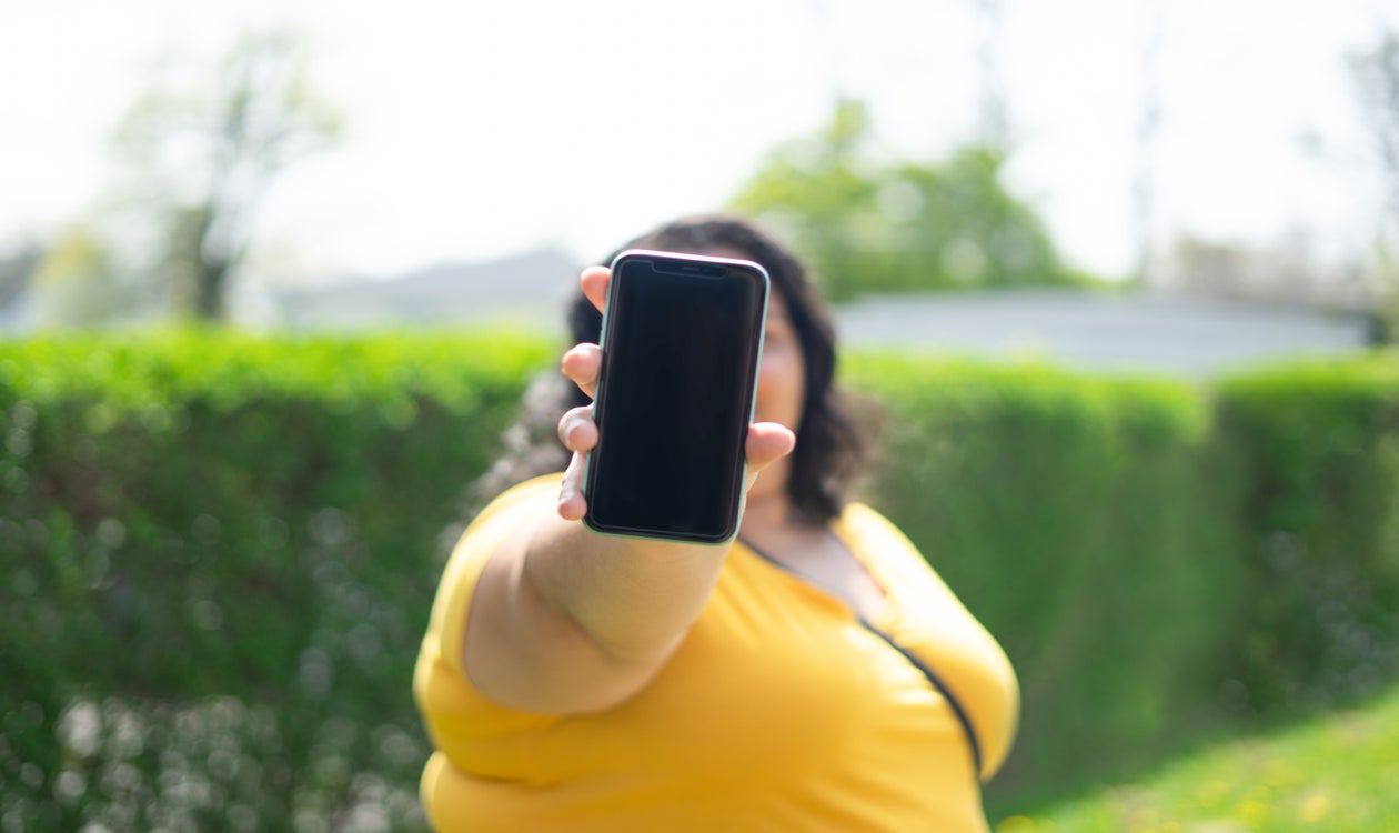 Woman holding up a phone
