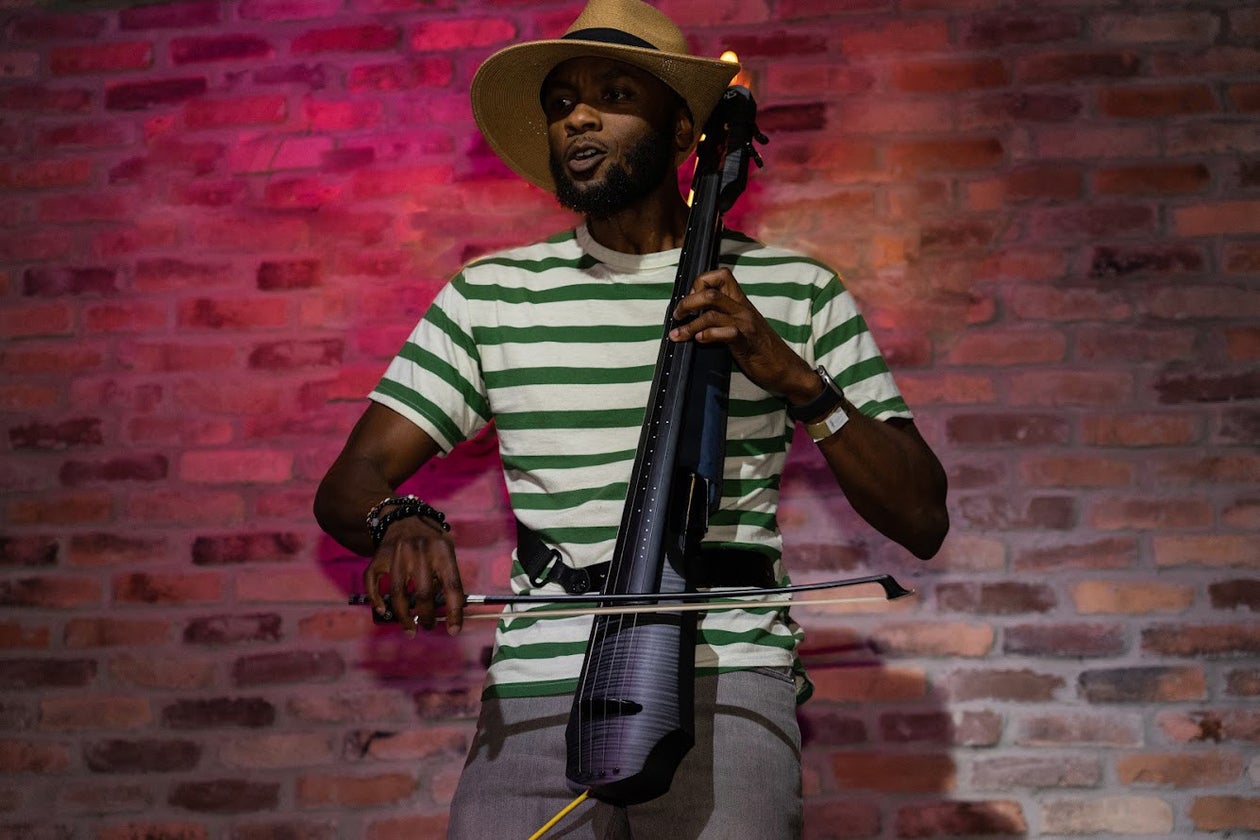 Man Playing Electric Cello on Stage