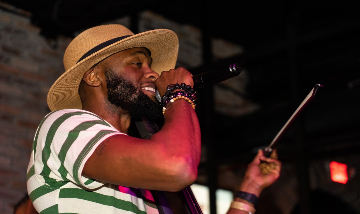 Singer with Tablet Performs at Gig