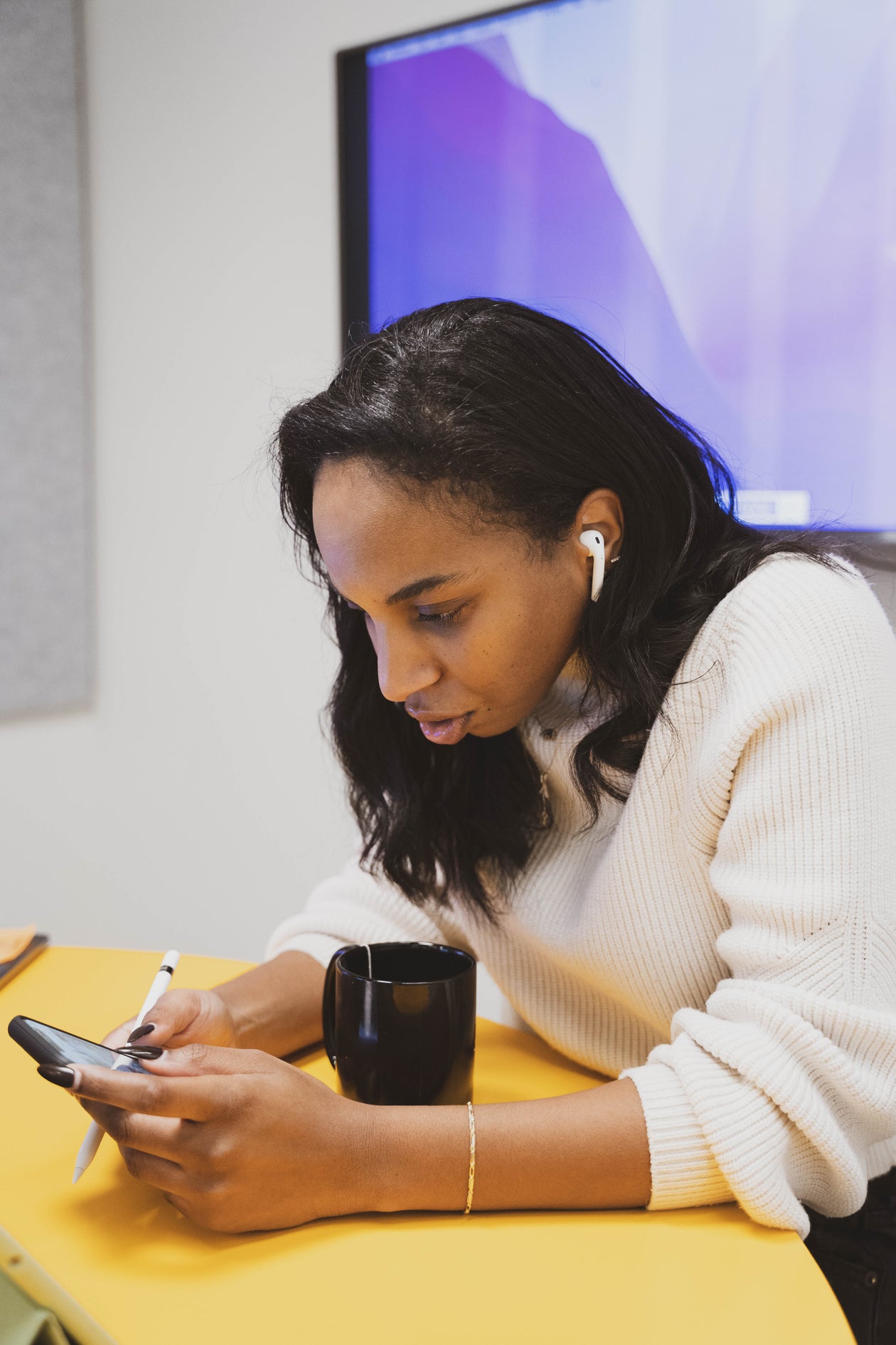Office Scene: Woman Engaged in Work On Smartphone