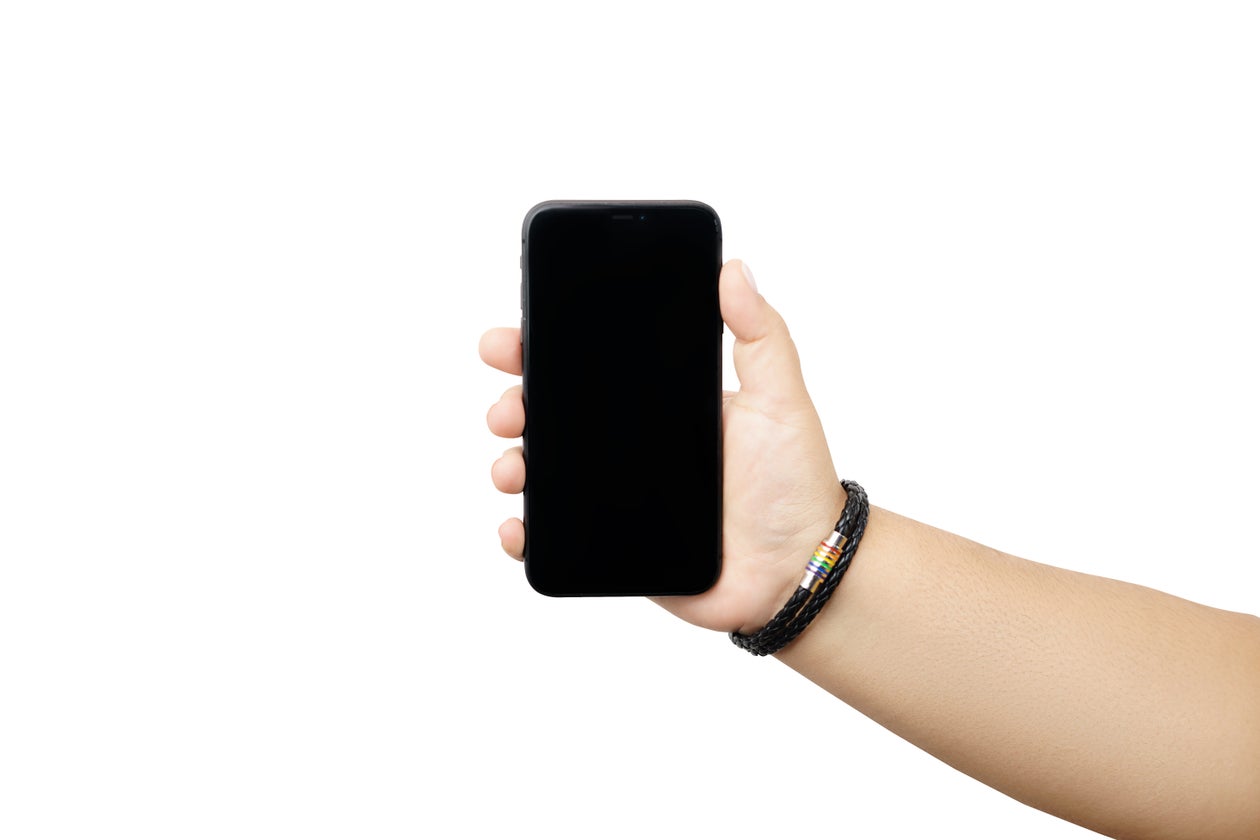 LGBTQIA pride member-ally holding a phone