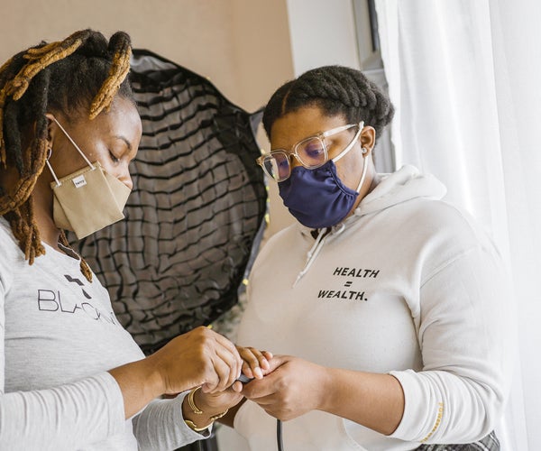 Two Black women collaborating on work
