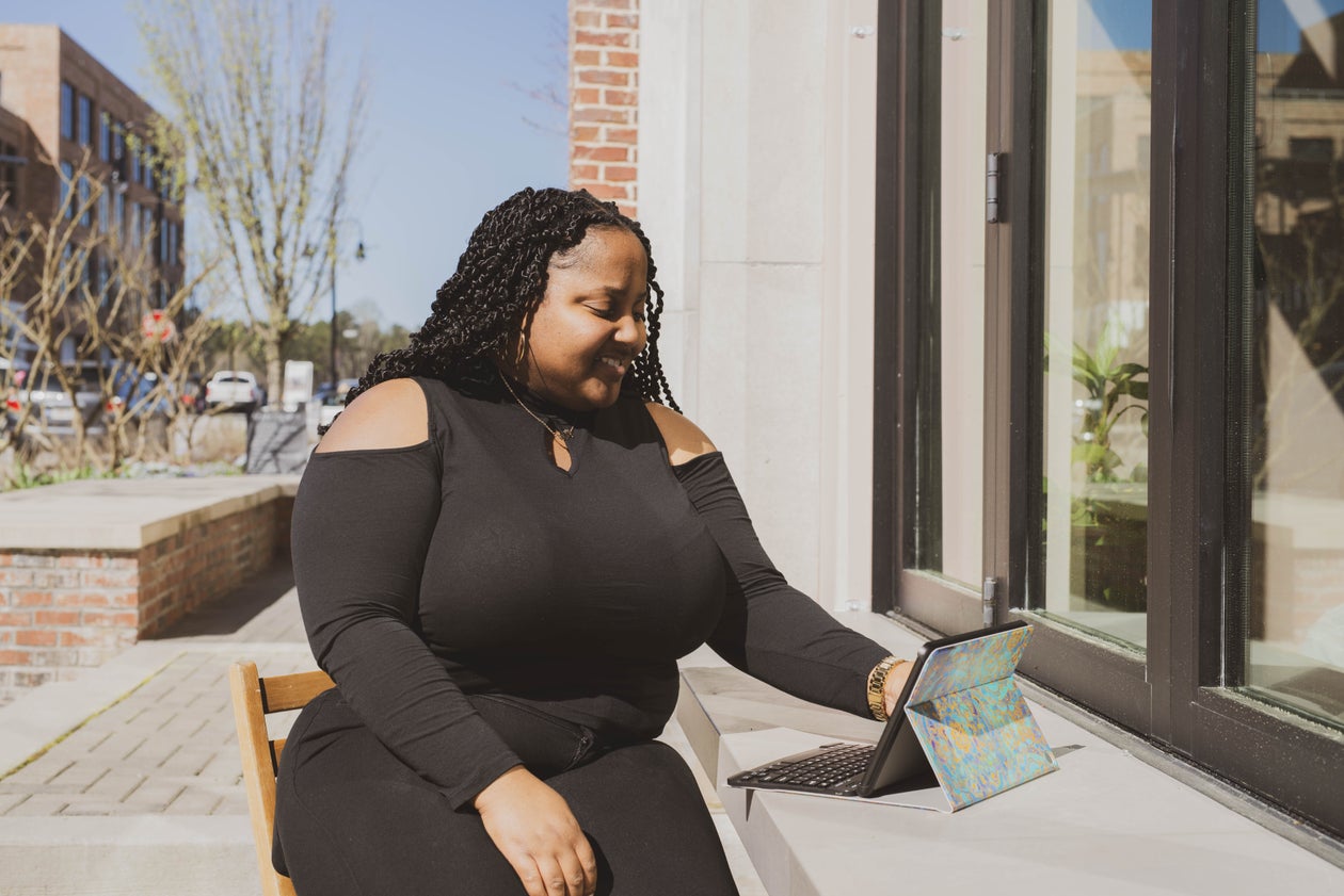 Woman Relaxing with Tablet Outside