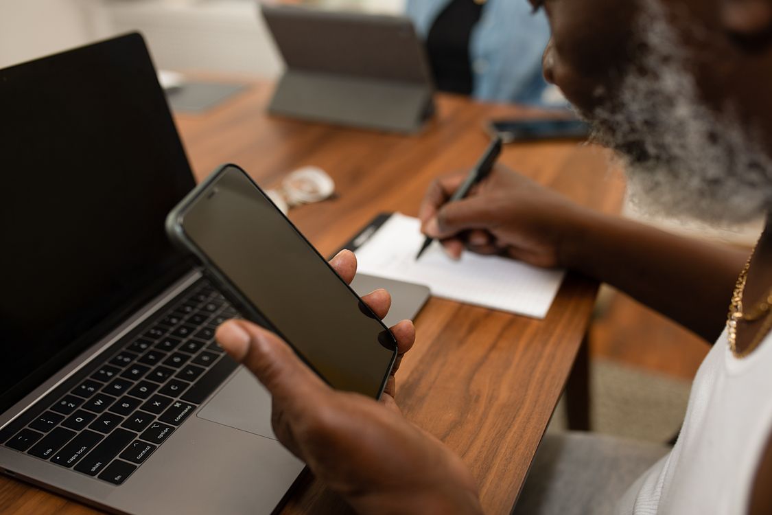 Person with beard holds phone