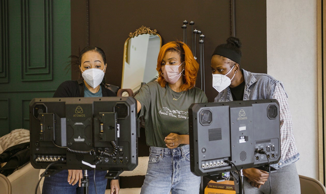 Black Woman behind filming equipment