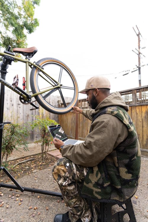 Bike Maintenance: Man Using Laptop