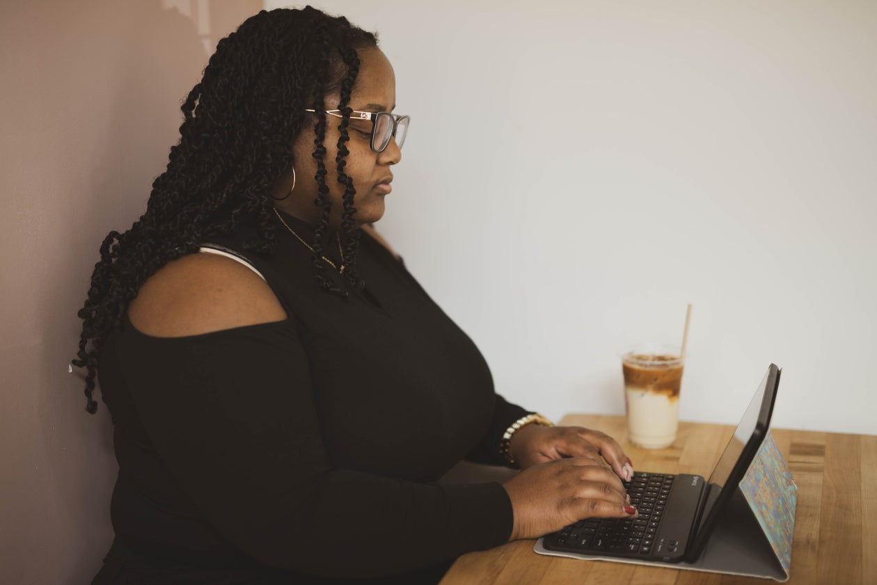 Woman Engrossed in Her Tablet at the Cafe