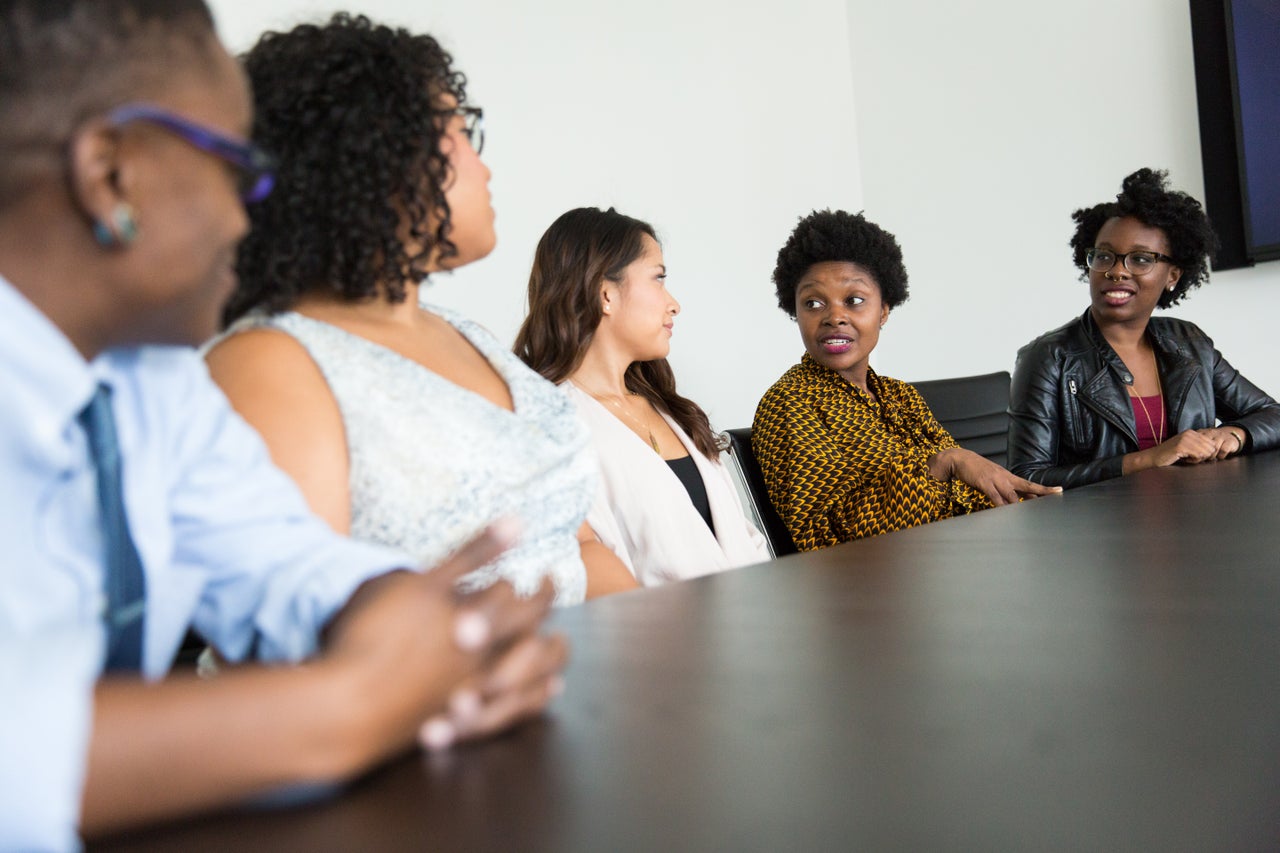 A team reviews information together around a conference table