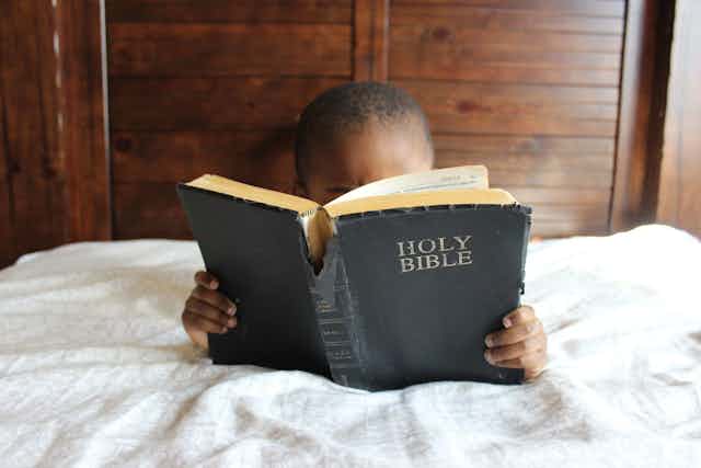 Boy reading his bible