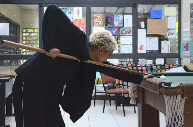 Woman playing pool indoors