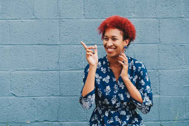 Woman laughing and pointing