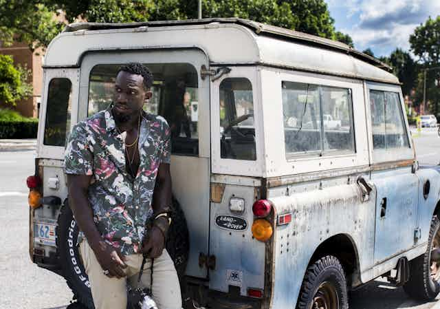 Man leaning on car