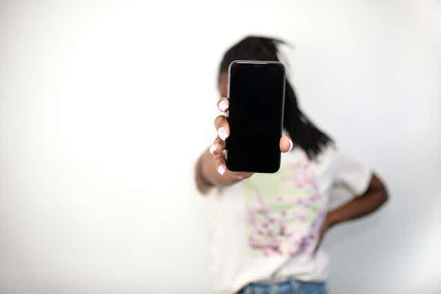 Girl holding up a phone