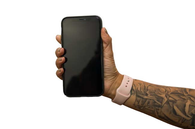 Right hand with watch holds phone