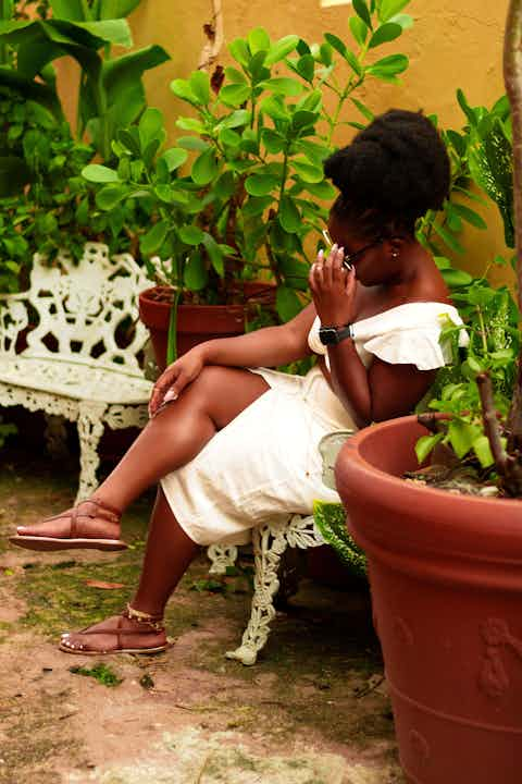 Woman sitting with plants