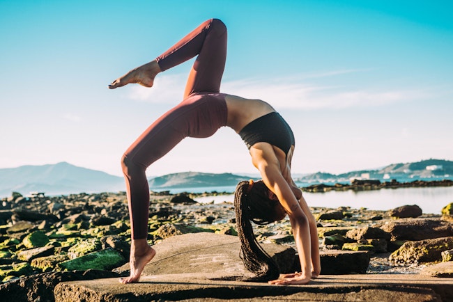 Woman in One-Legged Wheel Yoga Pose