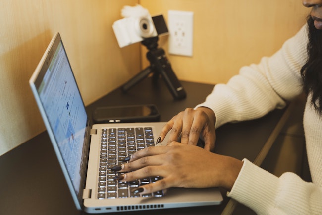 Professional Woman on Laptop with Camera