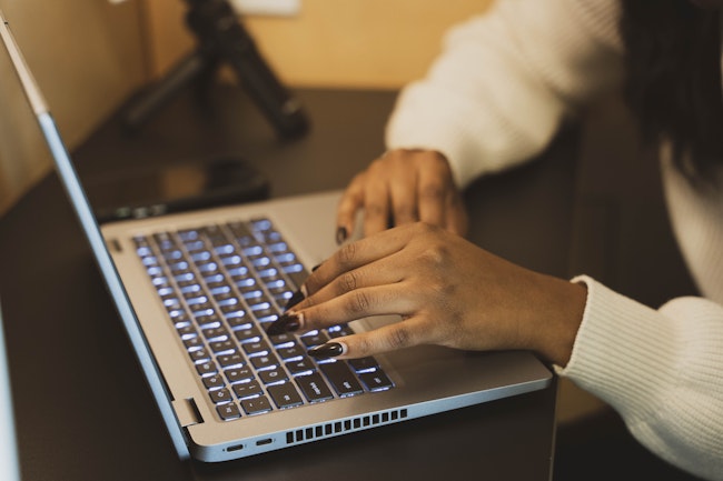 Close-up of Woman's Hands on Laptop Keyboard