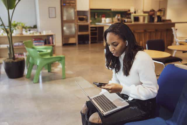 Woman Engaged in Laptop Work in an Office