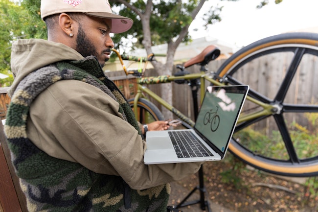 Man Browsing Bikes on His Laptop