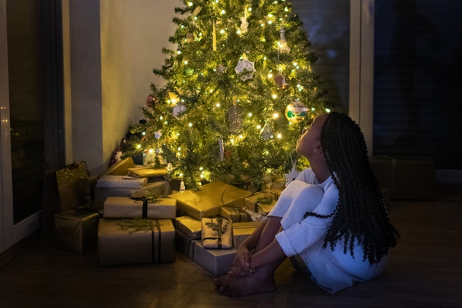Girl at Night by the Christmas Tree