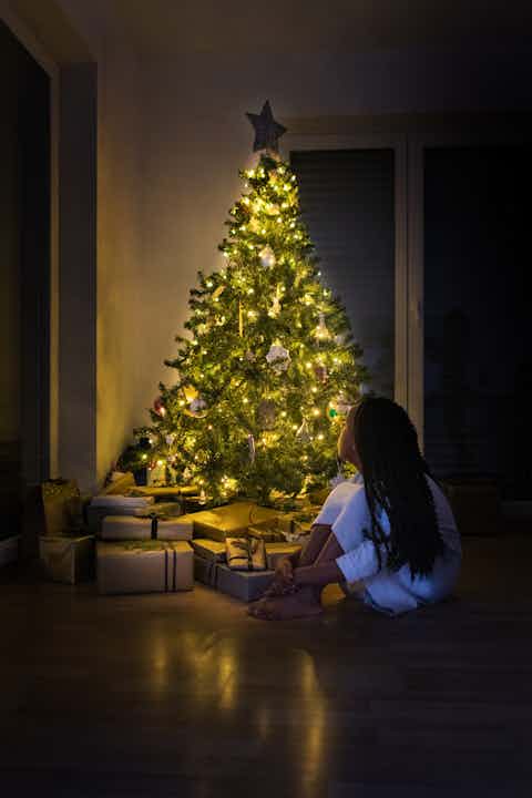 Girl at Night by the Christmas Tree
