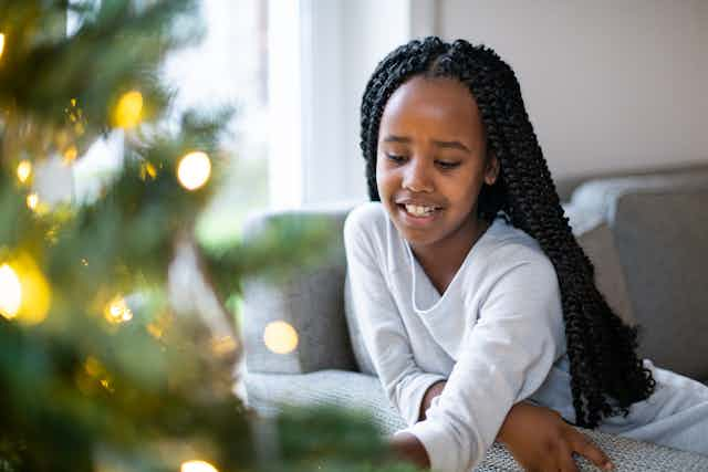 Girl by the Christmas Tree