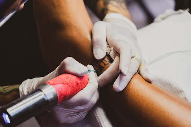 Tattoo Machine and Skin Close-up