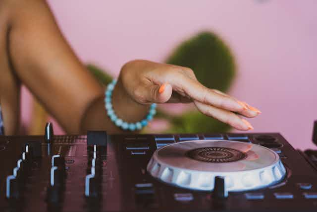 Hand on DJ Turntable