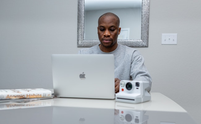 Creative Workspace of a Man with Laptop and Camera