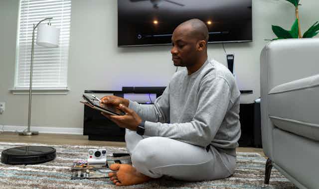 Man Sitting on Floor with Tablet
