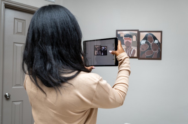 Woman Capturing Artwork with iPad Tablet