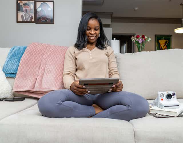 Home Entertainment: Woman on Couch Using iPad