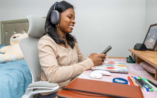 Remote Work: Woman with Earphones at Desk