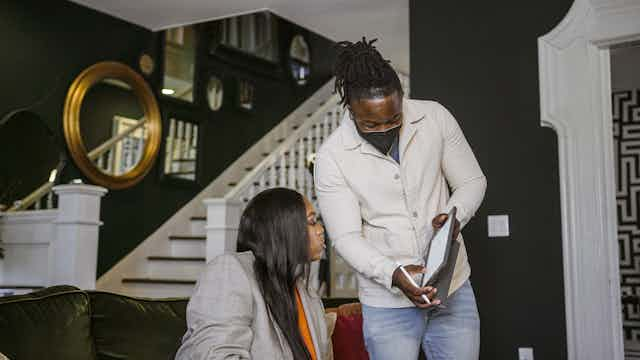 Man showing an iPad to a woman